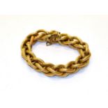 A yellow textured fancy link bracelet, length 21cm. Applied with later plaque stamped '750'. Gross