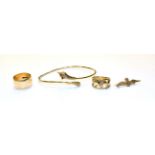 Two 9 carat gold rings, differing designs, finger sizes N, an RAF brooch, stamped '9CT' and a 9