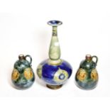 A pair of Royal Doulton stoneware bottle form jugs, floral decoration, together with a bottle