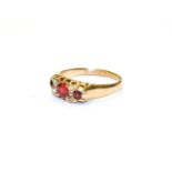 An 18 carat gold garnet topped doublet and diamond seven stone ring, finger size O. Gross weight 3.0