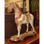 A Victorian leather, horse hair and wood pull along toy horse, approximately 68.5cm high by 67cm