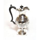 A Victorian silver hot water jug, Chester, 1899, baluster and on square base, the sides chased