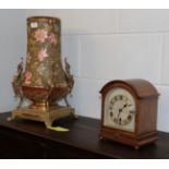 A Victorian pottery vase converted to a lamp with gilt metal mounts and a 1920's chiming mahogany