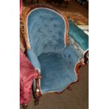 A Victorian carved walnut armchair, upholstered in blue velvet