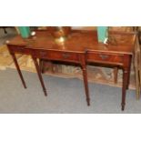 A reproduction mahogany break front hall table with three drawers and fluted legs, 152cm wide by