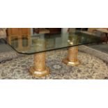 A modern rectangular glass top dining table, raised on twin Italian elaborate parcel gilt column
