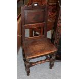 A 17th century panel back oak chair