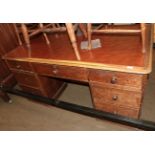 An early 20th century oak leather top desk, one side fitted with drawers, the opposing side with