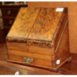 A Victorian walnut and figured walnut table top stationary cabinet, the sloping doors