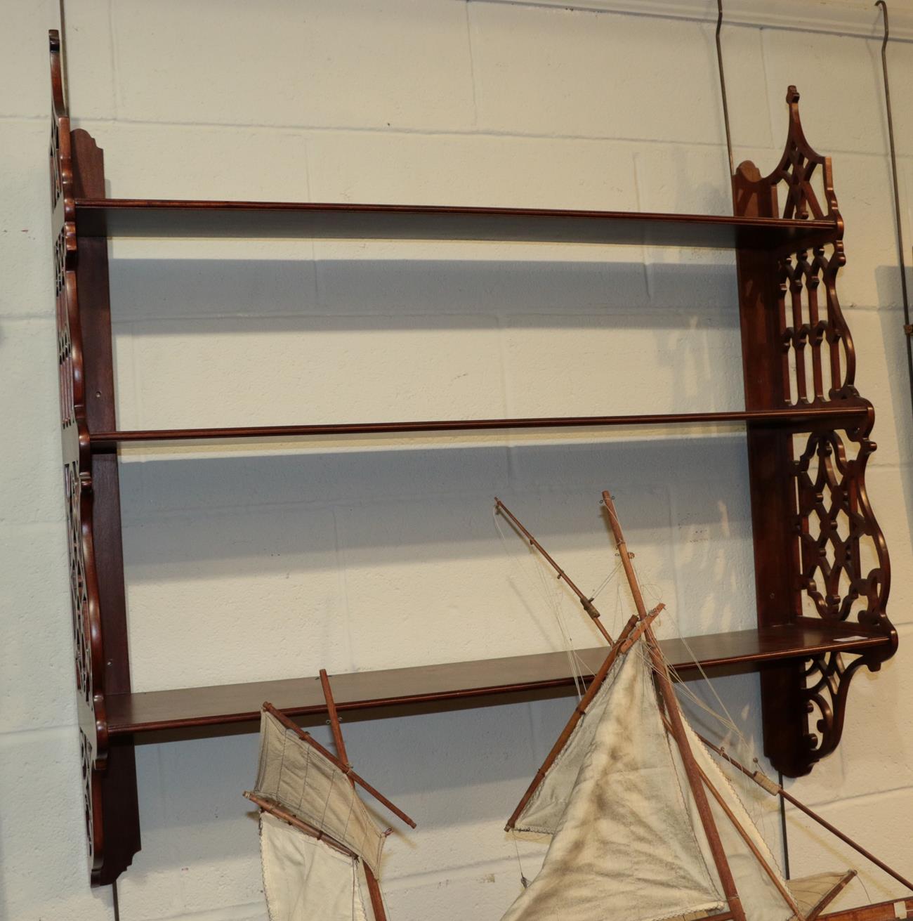 A mahogany fret-carved hanging set of three shelves, 91cm high by 93cm wide