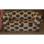 A Victorian Chesterfield settee, re-upholstered in black floral fabric