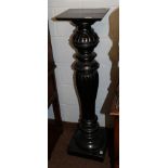 An ebonised plant pedestal