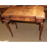 A George III mahogany fold over tea table