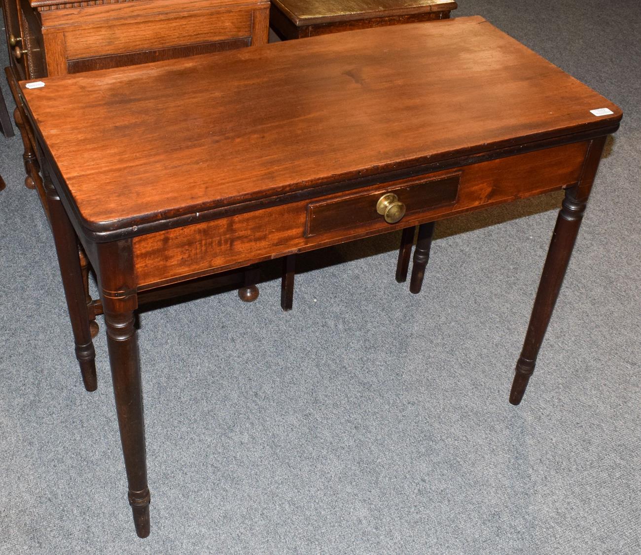 A Victorian mahogany fold over tea table, with a single drawer, 96cm wide by 46.5cm by 75cm high
