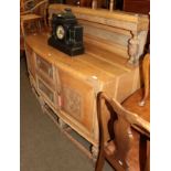 An early 20th century carved oak buffet back sideboard with pineapple carved legs