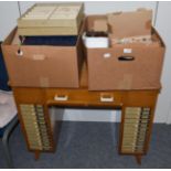 An early 20th century oak opticians desk together with collection of spectacles, lenses, two