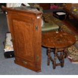 A reproduction oak drop leaf oval coffee table, 67cm extended by 53cm deep by 50cm high; and an