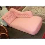 A late Victorian chaise lounge upholstered in pink fabric raised on turned legs