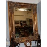 A reproduction gilt framed bevelled glass mirror