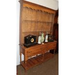A reproduction oak dresser and rack
