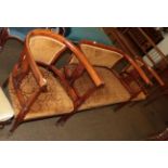 An Edwardian stained beech salon settee and two tub chairs (3)