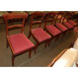 A set of six late Regency mahogany dining chairs, with curved back support and striped drop in seats
