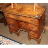 A 1920's figured walnut and cross banded kneehole dressing table, 85cm wide by 42cm deep by 71cm