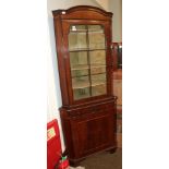 A mahogany free standing corner cupboard