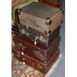 Three brown crocodile leather travel cases, one with dust cover, case stamped A. Barrett & Sons.