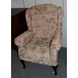 A modern wingback chair with floral upholstery