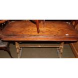 A Victorian cast iron pub table, pine top on two supports