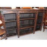 A dark oak break front bookcase