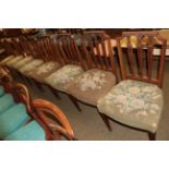 A set of eight late 19th/early 20th century carved mahogany dining chairs on fluted legs