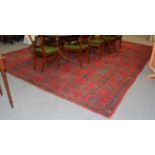 Ushak carpet, the tomato red field with columns of geometric medallions, enclosed by borders of