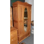 An early 20th century oak mirror door wardrobe; a walnut cabinet with sliding glass doors; an