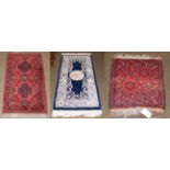 Chinese rug, the indigo field with roundel medallion enclosed by floral borders 160cm by 78cm