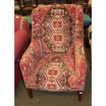 An early 20th century armchair covered in geometric pattern