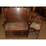 An early 20th century carved oak monks' bench, and an upholstered corner chair