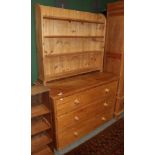 A pine three-drawer chest and a pine bookcase with four fixed shelves