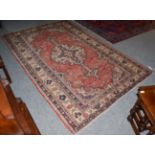 Ardabil rug, the terracotta field with central ivory medallion framed by spandrels and borders of