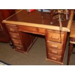An early 20th century pine desk with leather top, 117cm wide, 71cm wide by 81cm high