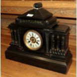 A Victorian ebonised architectural form striking mantel clock