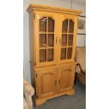 A reproduction oak display cabinet with two glazed doors and two cupboard doors