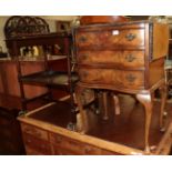 A reproduction mahogany break-front sideboard in a 20th century walnut veneered three-drawer chest