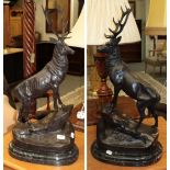 A pair of reproduction bronze stags on marble bases
