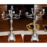 A Pair of Silver Plated Seven-Light Candelabra, each on square base, the corners applied with cast