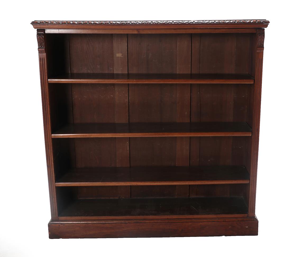 A Victorian Carved Walnut Free-Standing Open Bookcase, labelled James Shoolbred, Tottenham Court,