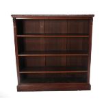 A Victorian Carved Walnut Free-Standing Open Bookcase, labelled James Shoolbred, Tottenham Court,