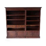 A Victorian Mahogany Free-Standing Bookcase, late 19th century, in two sections, the moulded top