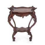 A Late 19th Century Italian Carved Walnut Two-Tier Occasional Table, the removeable tray top with